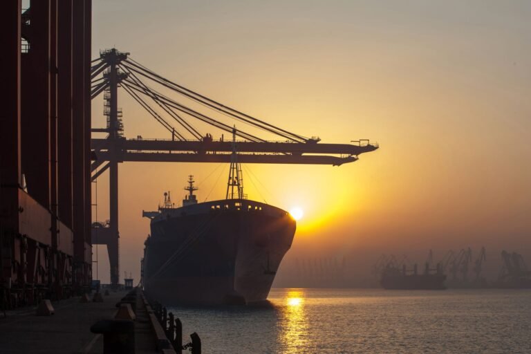 Container ship being worked by cranes at port